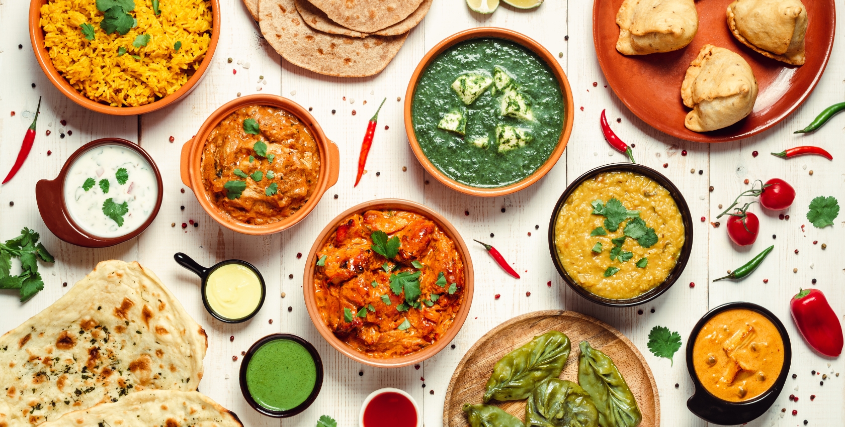 Indian platter with samosas, curries, naan, and rice